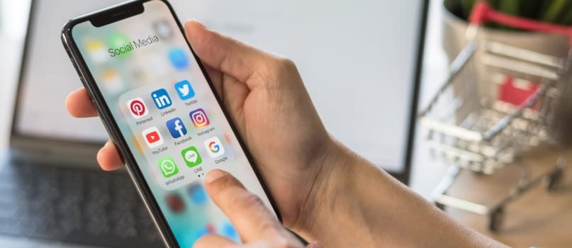 A smartphone social media applications tab representing a mobile app development company social media marketing service